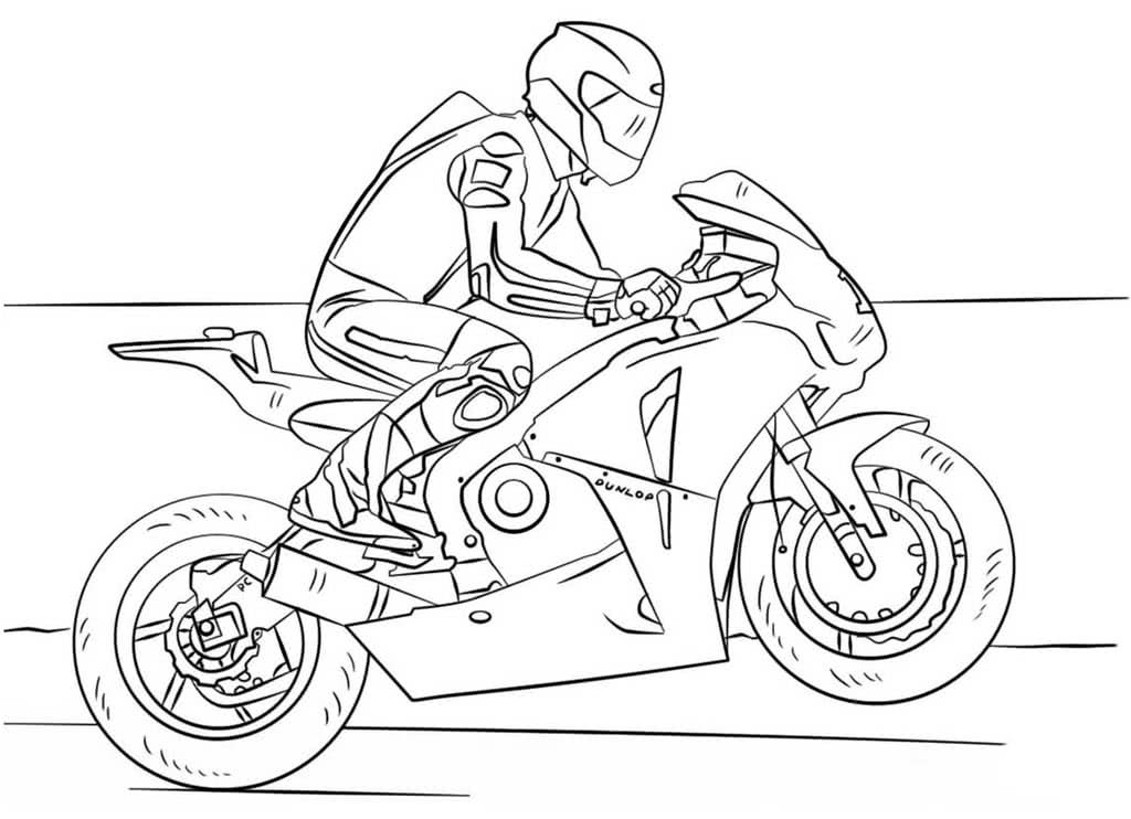 Спортивный мотоцикл с гонщиком едет по дороге